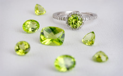 A group of loose and set peridot gems