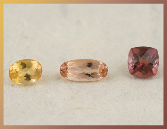 A group of three loose Topaz gemstones