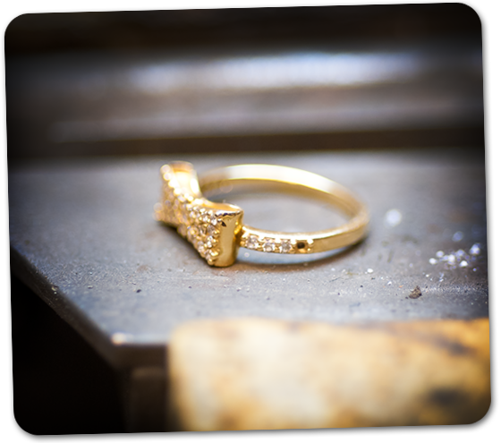 A yellow gold ring with a missing diamond