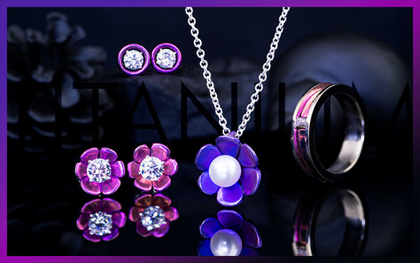 A group of three pieces of purple titanium jewelry with the subtle text Titanium behind them