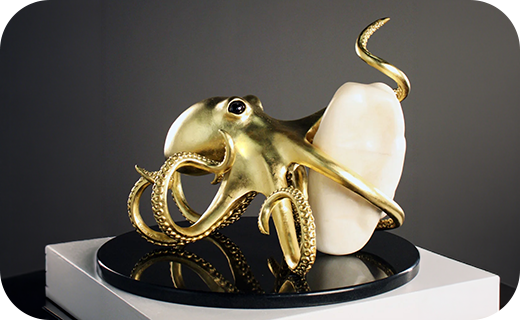 The gigapearl on display with its golden octopus