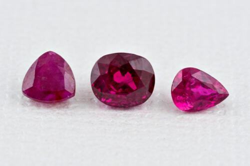 Three loose rubies in a row triangle oval and pear shaped