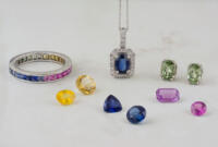 Collection of sapphire jewelry and loose sapphire gemstones in many colors