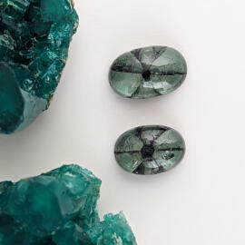 Two oval trapiche emerald cabochon gemstones