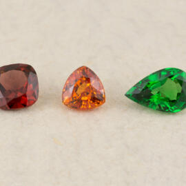 Three loose garnets red organge and green