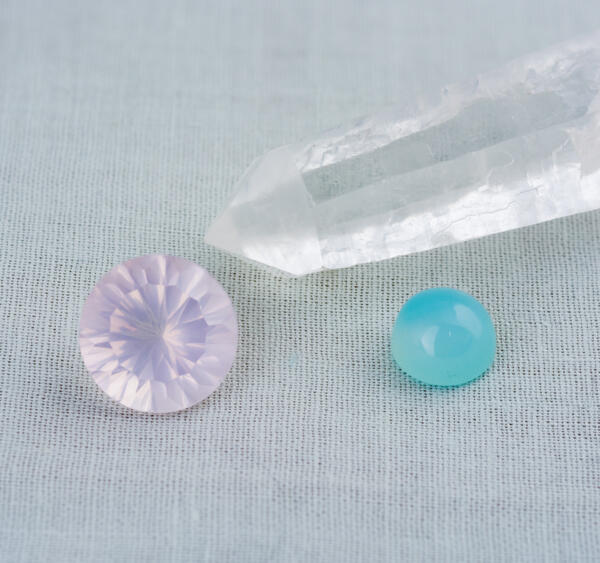 A rose quartz rock crystal and chalcedony next to each other