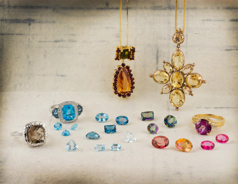Group of loose topaz gems and topaz jewelry