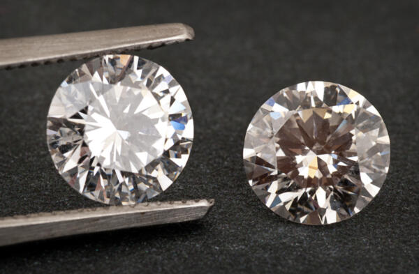 Natural diamond next to lab grown synthetic diamond