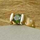 Green diamond engagement ring in yellow gold with diamond accents