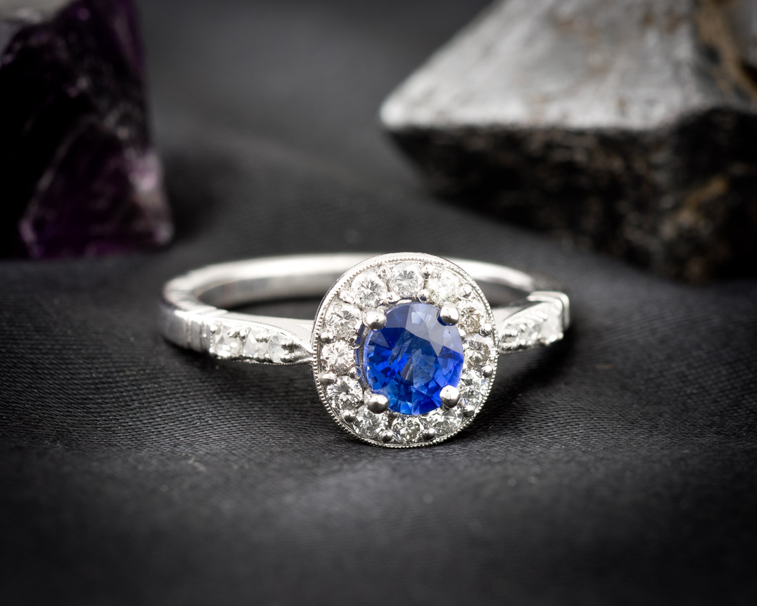 Non-traditional sapphire halo engagement ring
