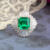 Custom green emerald engagement ring with ballerina halo