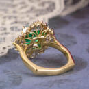 Custom green emerald engagement ring with ballerina halo - back