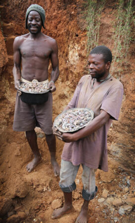 East African gem miners holding buckets of rough gemstones