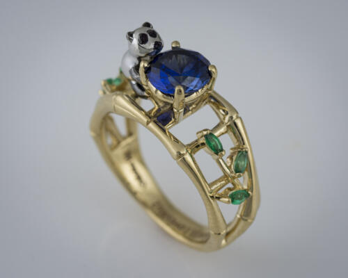edge of ring showing emeralds and sapphire