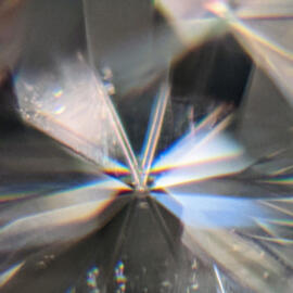 Close up image of doubled facet junctions on a moissanite under a microscope