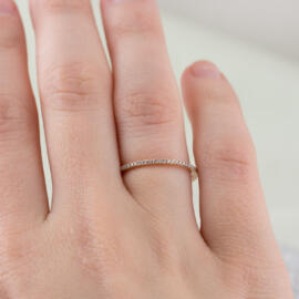 Thin rose gold diamond band on hand