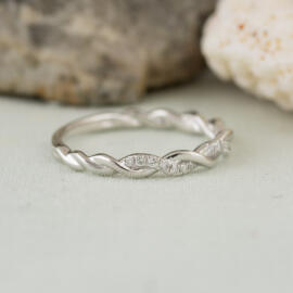 side angle white gold twisted diamond band on fancy background