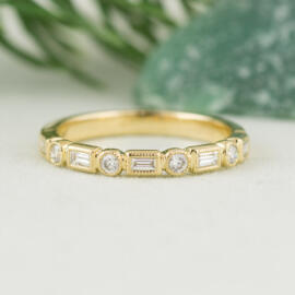 front angle fancy background yellow milgrain round and baguette diamond band