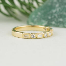 side angle fancy background yellow milgrain round and baguette diamond band