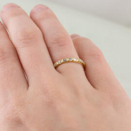 on hand yellow milgrain round and baguette diamond band