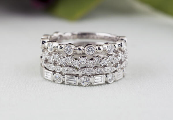 Group of stackable rings with four different white gold diamond bands