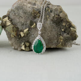 fancy background pear emerald diamond halo pendant front view