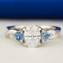 oval diamond with trillion aquamarine accents ring front view