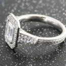Custom emerald cut diamond halo engagement ring with engraved accents top and side