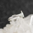Custom emerald cut diamond halo engagement ring with engraved accents side