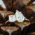 Two stone ring with pear and cushion cut lab diamond on yellow gold setting in pine cone