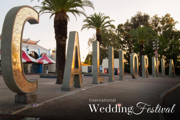 The California sign in front of Cal Expo with the International Wedding Festival logo beneath it