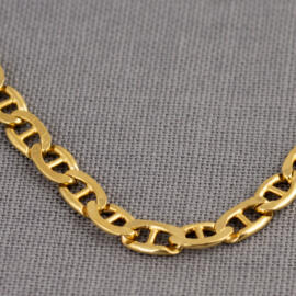 A close up show of a yellow gold anchor chain