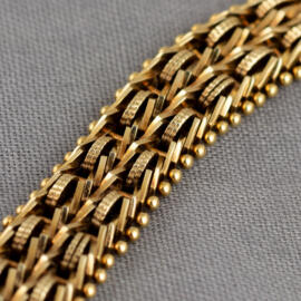 A close up of a yellow gold bismark chain