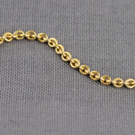 A close up shot of a yellow gold cable chain