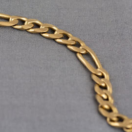 A yellow gold figaro chain