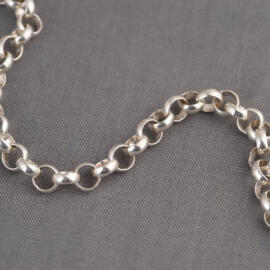 A close up shot of a silver rolo chain