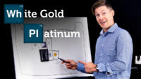 The text White Gold and Platinum is placed in front of a white board sketch of the periodic table of elements as Angelo the gemologist points to the elements