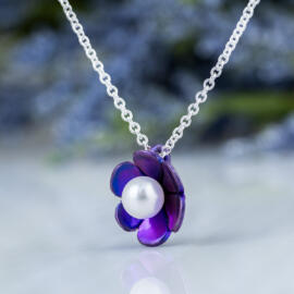Purple lotus blossom necklace with anodized titanium and round white Akoya pearl with sterling silver chain - angled view