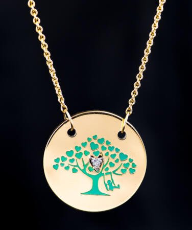 A yellow gold circle pendant with the light green xHope logo laser cut in the center