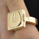 Hidden compartment letter U signet ring in 18k yellow gold closed on finger
