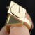 Hidden compartment letter U signet ring in 18k yellow gold partially open view
