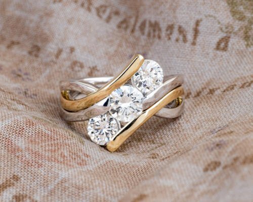 Custom three stone two tone engagement ring front view