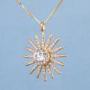 Large custom sun starburst pendant with lab diamonds in 18k yellow gold side view with blue background