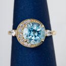 Custom blue topaz off center ring with diamond accents front view