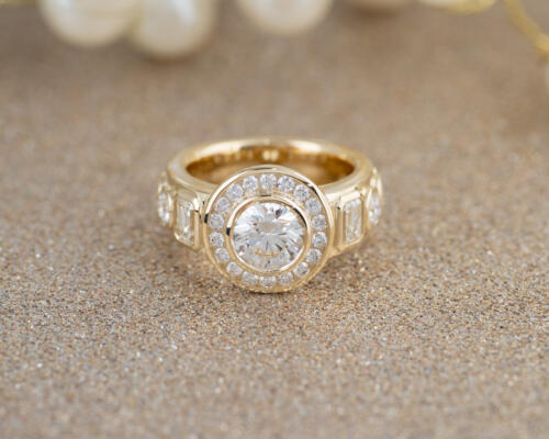 14 karat yellow gold custom diamond bezel ring with gold sparkle backdrop front view