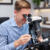 A gemologist at a microscope evaluating a piece of jewelry