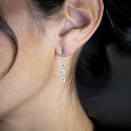 Lab grown drilled marquise diamond dangle earrings in 14k yellow gold on model left ear