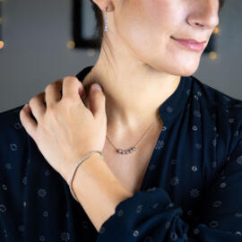 Lab grown drilled marquise diamond dangle earrings in 14k yellow gold on model with other pieces